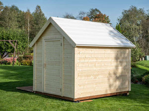 Natural wooden playhouse back view with a white roof and a side door in the backyard on green grass by WholeWoodPlayhouses