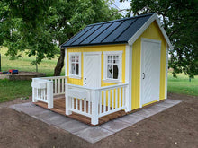 Load image into Gallery viewer, Yellow Wooden Playhouse with white fishbone doors and wooden terrace with white railing in the backyard by WholeWoodPlayhouses
